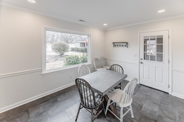 dining room with ornamental molding, wainscoting, visible vents, and recessed lighting