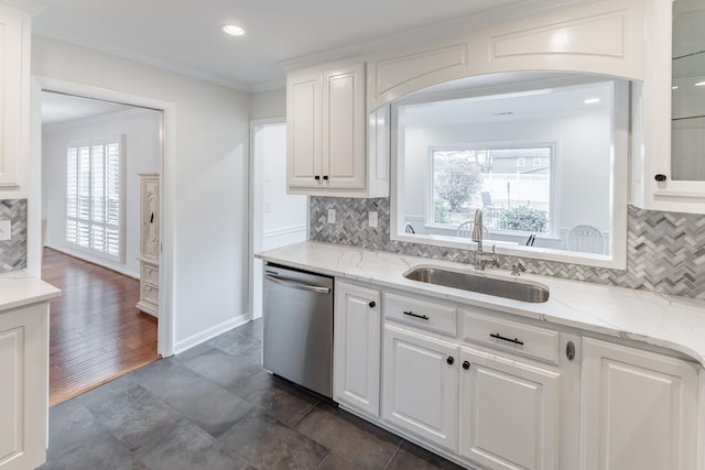 kitchen with dishwasher, light stone countertops, crown molding, white cabinetry, and a sink