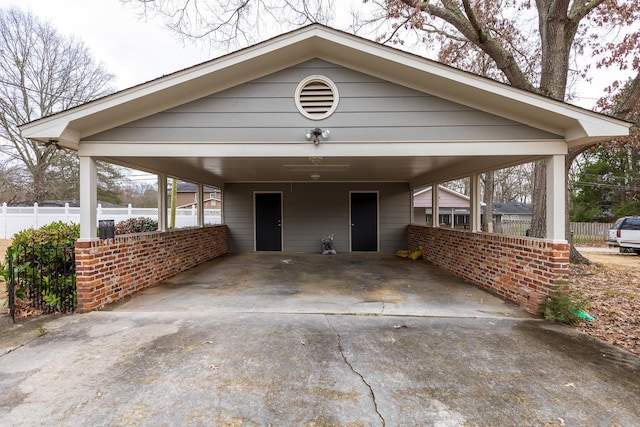 view of front of house featuring concrete driveway and fence