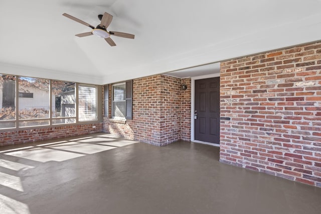 interior space with lofted ceiling and ceiling fan