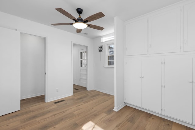 unfurnished bedroom featuring light hardwood / wood-style floors and ceiling fan