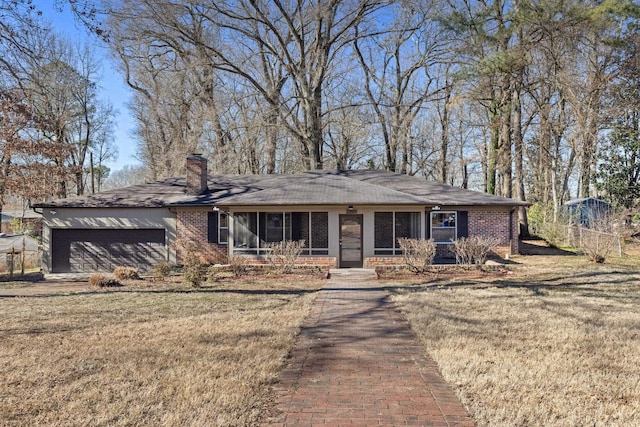 view of front of house with a garage and a front lawn