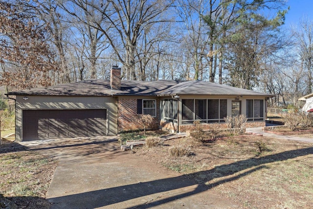 view of front of home with a garage and a sunroom