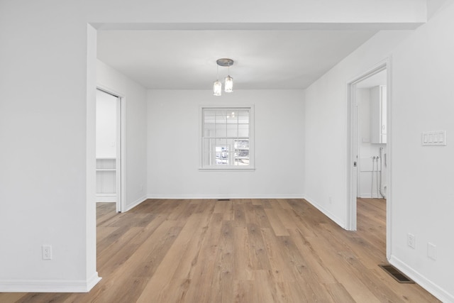 spare room featuring light wood-type flooring