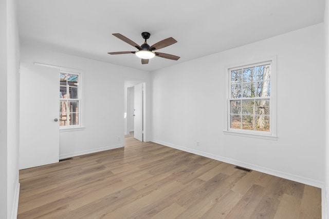 spare room with ceiling fan and light wood-type flooring