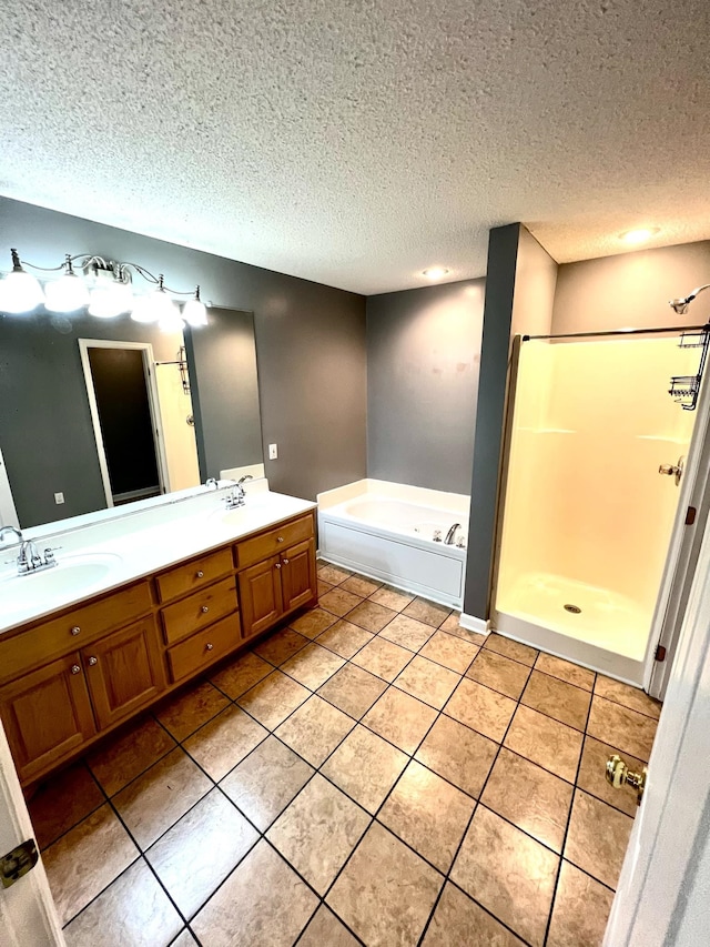 bathroom with vanity, a textured ceiling, tile patterned floors, and separate shower and tub