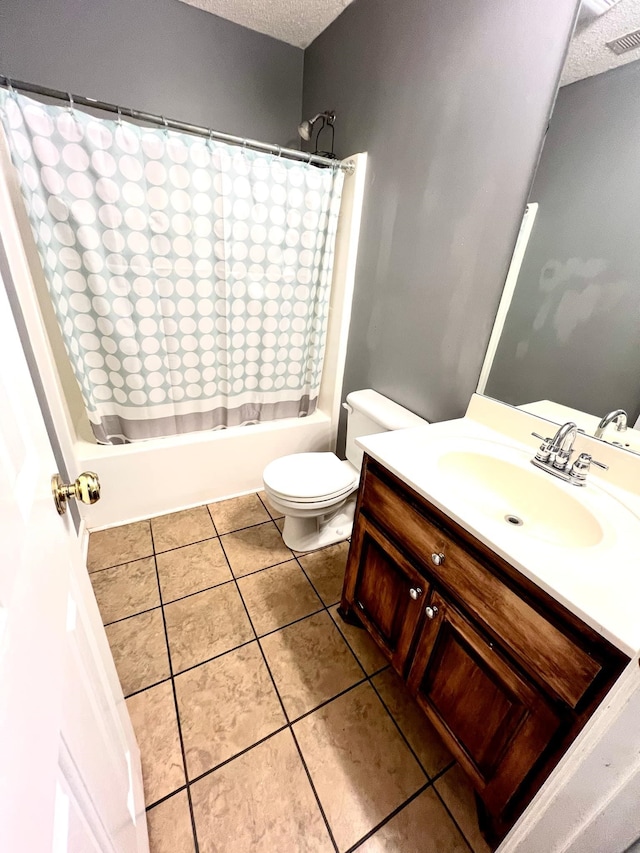 full bathroom with shower / tub combo with curtain, tile patterned flooring, vanity, a textured ceiling, and toilet