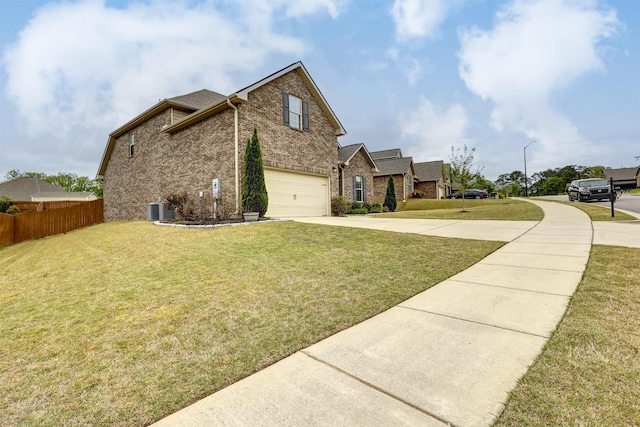 view of side of property with an attached garage, cooling unit, fence, driveway, and a yard