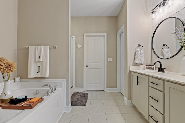 bathroom with a stall shower, tile patterned floors, a bath, and vanity