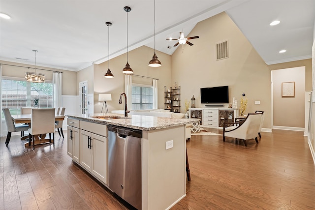 kitchen with a sink, visible vents, open floor plan, stainless steel dishwasher, and dark wood finished floors