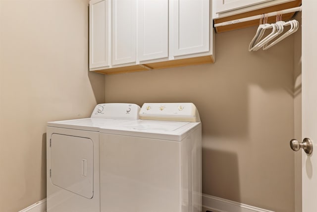 clothes washing area featuring cabinet space, baseboards, and independent washer and dryer