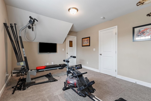 exercise room featuring carpet and baseboards