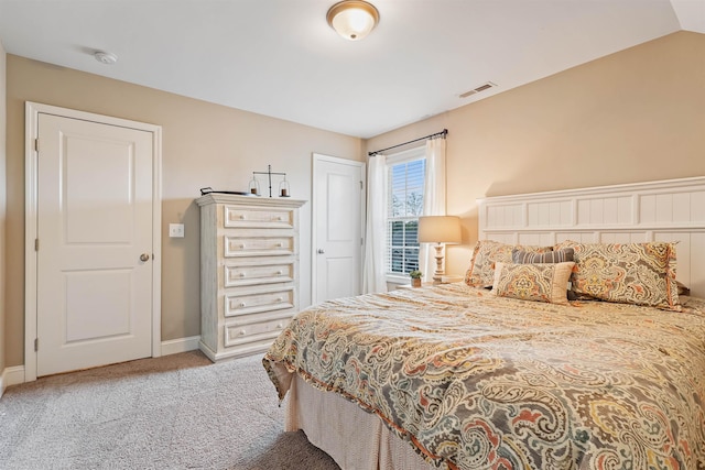 bedroom featuring lofted ceiling, carpet, visible vents, and baseboards