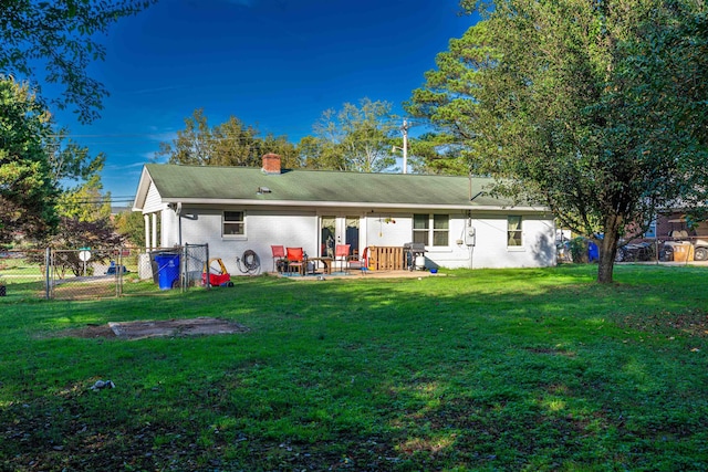 back of property featuring a yard and a patio