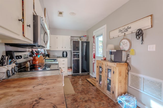 kitchen featuring white cabinetry and appliances with stainless steel finishes