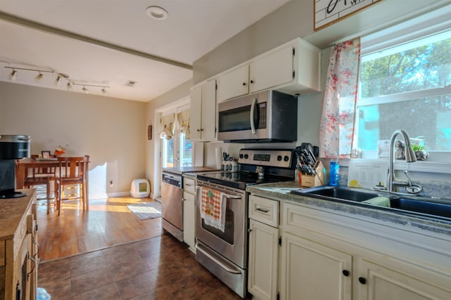 kitchen with white cabinetry, sink, and appliances with stainless steel finishes