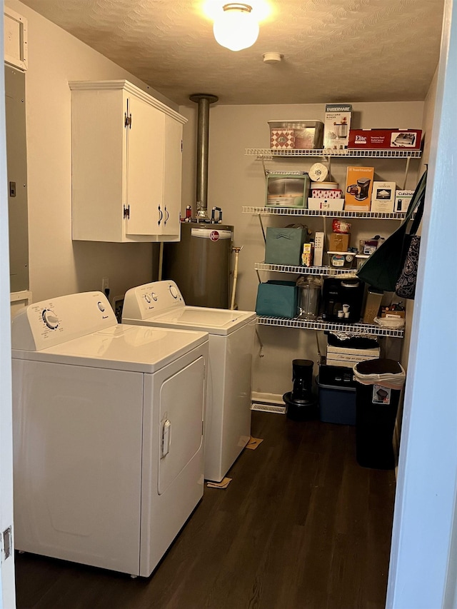 laundry area with cabinets, dark wood-type flooring, washer and dryer, a textured ceiling, and water heater