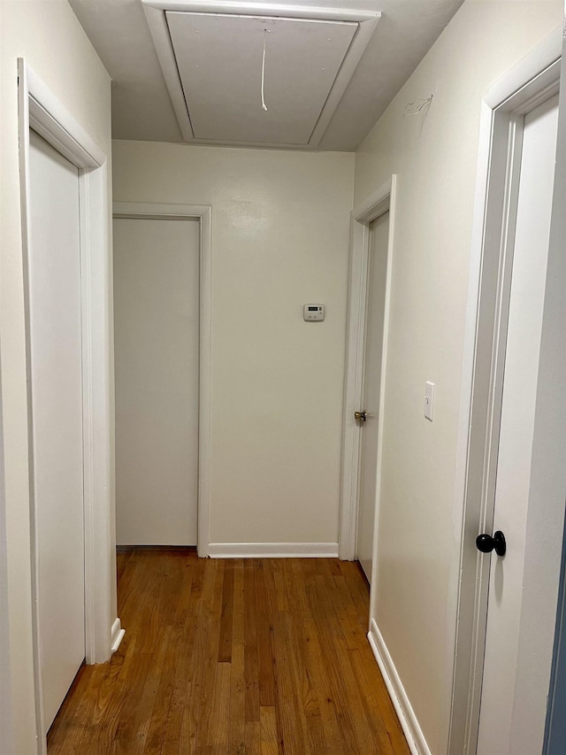 hallway with hardwood / wood-style flooring