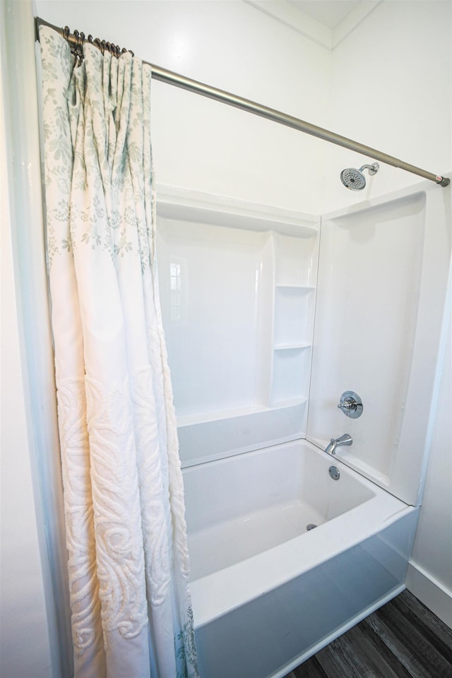 bathroom with shower / tub combo and wood finished floors