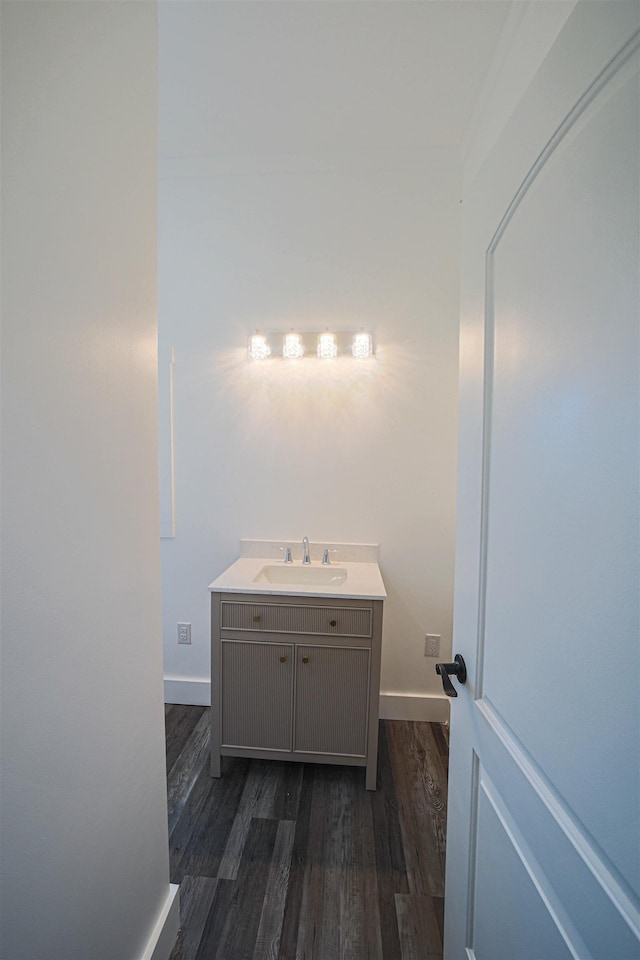 bathroom featuring wood finished floors, vanity, and baseboards