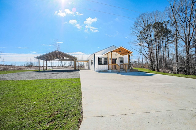 view of front of house with board and batten siding, driveway, and a front lawn