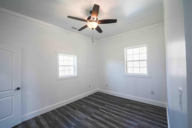 unfurnished room featuring a healthy amount of sunlight, dark wood-style floors, baseboards, and visible vents