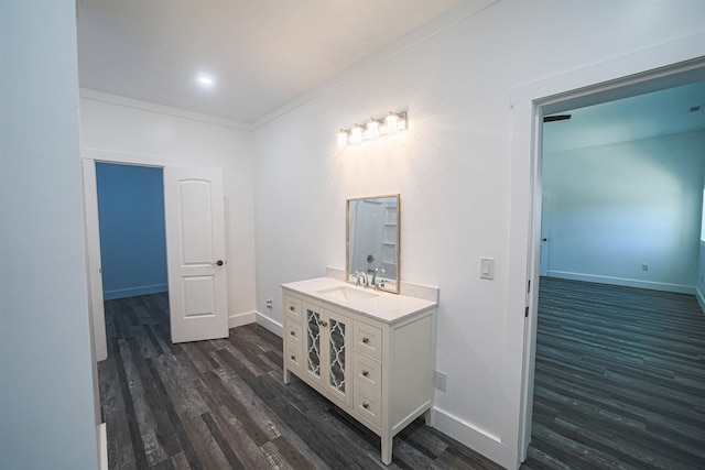 bathroom with vanity, baseboards, and wood finished floors