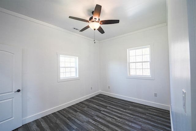 unfurnished room with baseboards, visible vents, dark wood finished floors, and a wealth of natural light