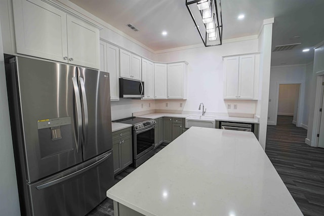 kitchen with dark wood-style floors, stainless steel appliances, a sink, and visible vents