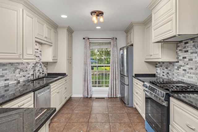  - kitchen featuring stainless steel appliances, a sink, premium range hood, backsplash, and recessed lighting