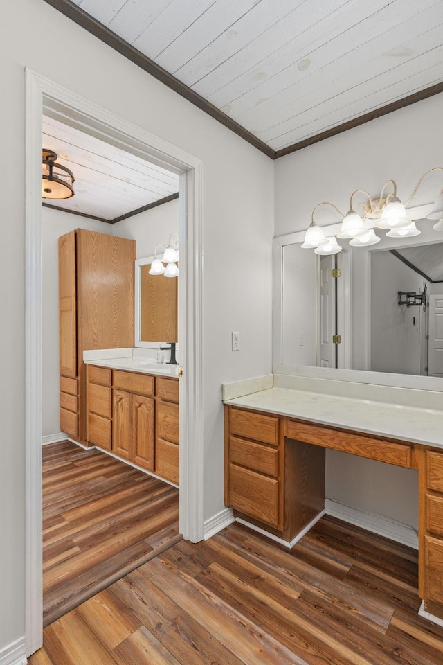  - full bath with ornamental molding, vanity, wood finished floors, and a chandelier