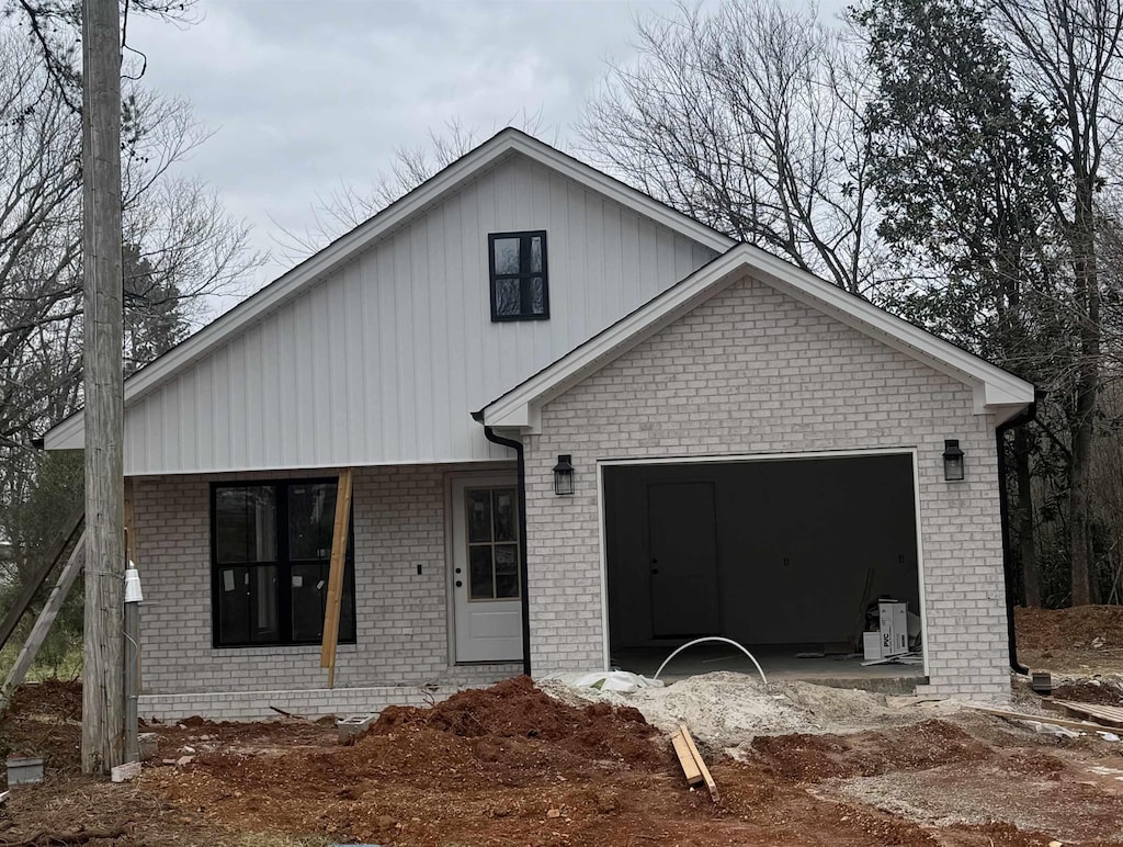 view of front of property featuring brick siding and an attached garage