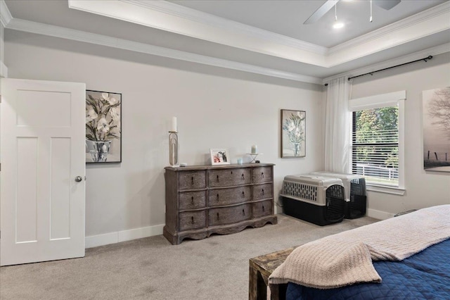 bedroom with light carpet, a tray ceiling, ceiling fan, and ornamental molding