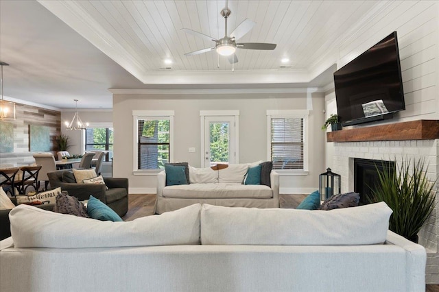 living room with a fireplace, wooden ceiling, ceiling fan with notable chandelier, and wood-type flooring