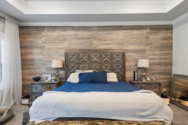 bedroom featuring carpet, wood walls, and a tray ceiling