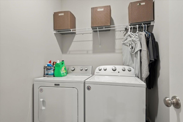 clothes washing area with washer and clothes dryer