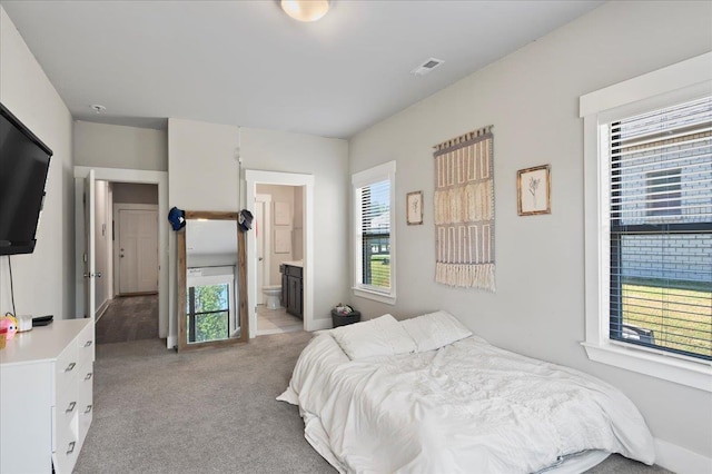 carpeted bedroom with ensuite bathroom