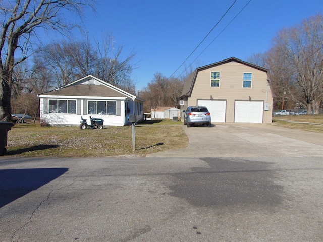 view of side of property featuring a garage and a yard