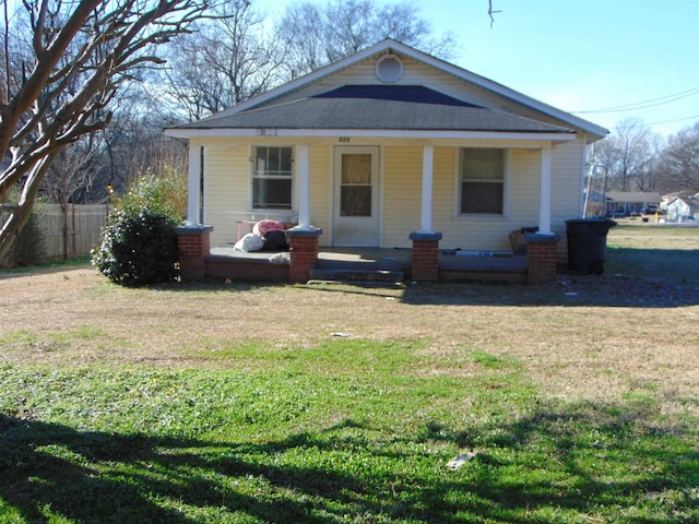 view of front of house with covered porch and a front yard