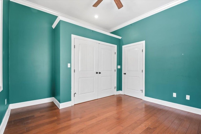 spare room with ceiling fan, hardwood / wood-style floors, and crown molding