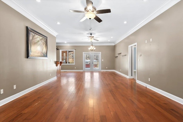 unfurnished living room featuring ceiling fan with notable chandelier, french doors, hardwood / wood-style floors, and crown molding