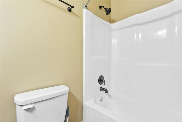 bathroom with toilet and tub / shower combination