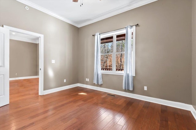 spare room with ceiling fan, crown molding, and hardwood / wood-style flooring