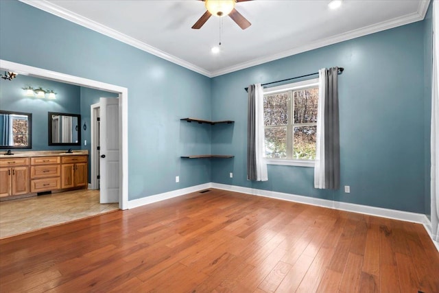 unfurnished room with sink, ceiling fan, light hardwood / wood-style floors, and crown molding