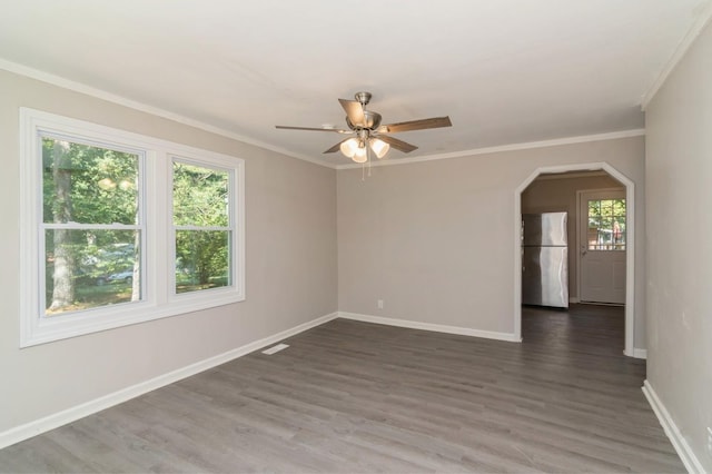 spare room featuring dark hardwood / wood-style flooring, ceiling fan, and ornamental molding