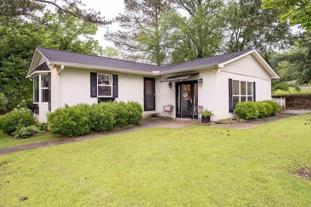  - ranch-style house with stucco siding and a front yard