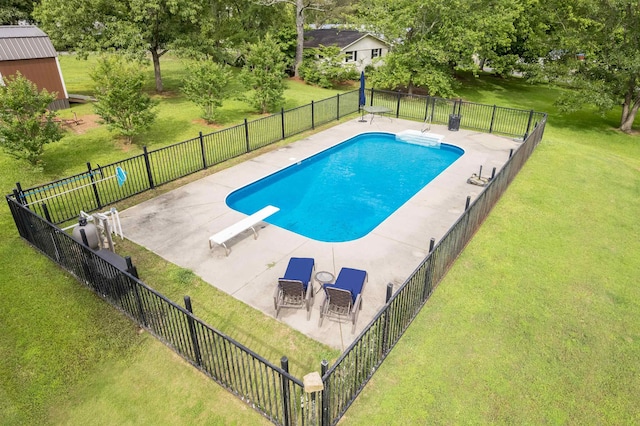  - view of swimming pool featuring a diving board, a patio, and view of scattered trees