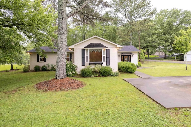  - ranch-style house with a front lawn and stucco siding