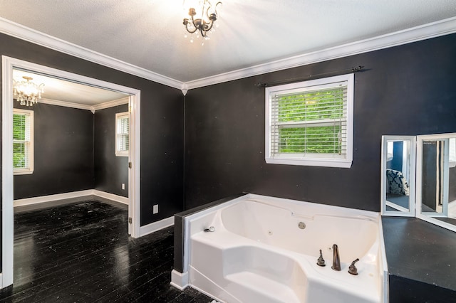  - bathroom with a chandelier, a whirlpool tub, healthy amount of natural light, ornamental molding, and hardwood / wood-style floors
