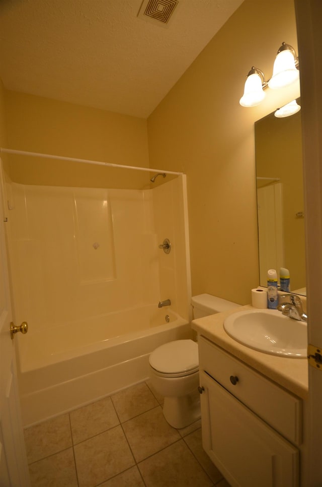 full bathroom featuring shower / bathing tub combination, tile patterned flooring, vanity, toilet, and a textured ceiling